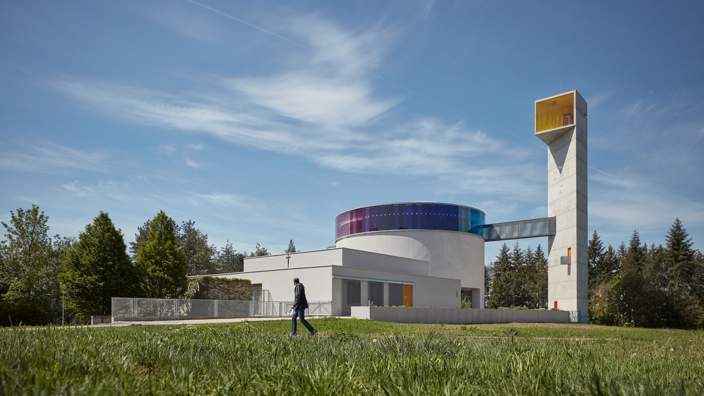 Atelier Štěpán tops circular church with rainbow stained-glass window